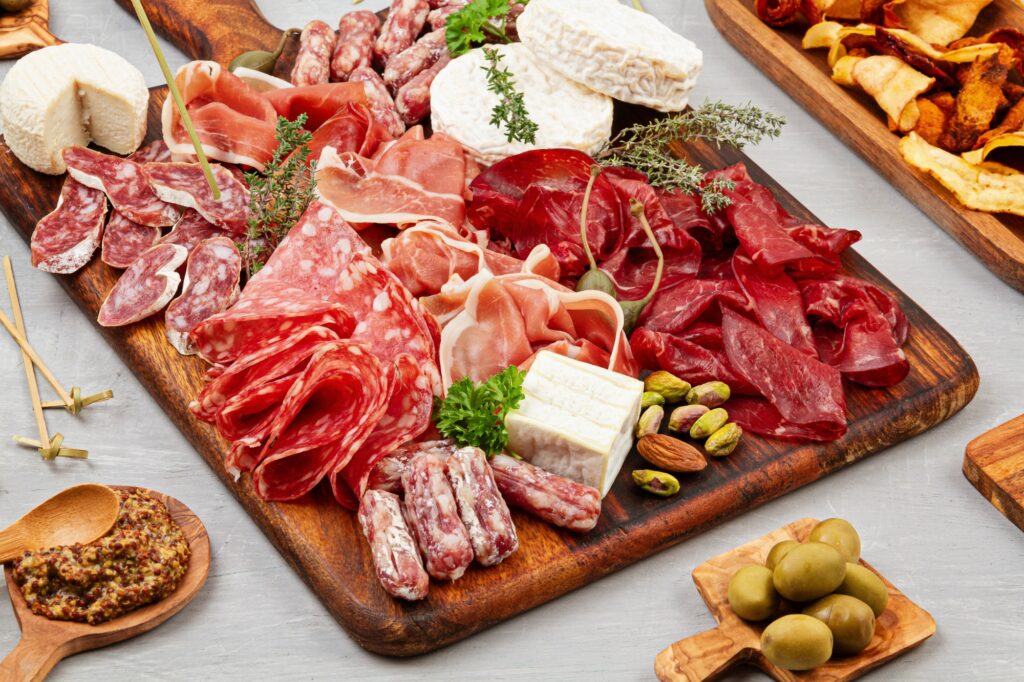 Appetizers table with differents antipasti, charcuterie, snacks and wine